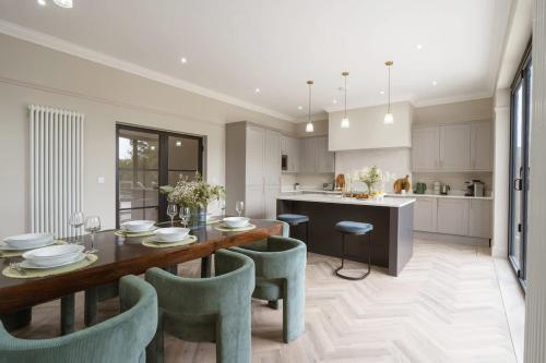 a kitchen and dining room with a table and chairs at Our House Collective - Luxury Stay in Lincoln City Centre, Hot tub, Sleeps 16 in Lincoln