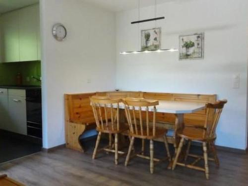 a kitchen with a wooden table and chairs at Apartment Nicole 1 by Interhome in Blatten bei Naters