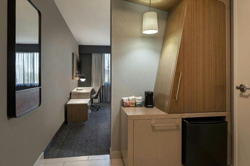 an office with a hallway with a desk and a room with at Courtyard by Marriott Sacramento Midtown in Sacramento