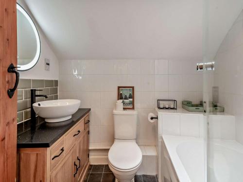 a bathroom with a toilet and a sink and a tub at 2 Bed in Ambleside oc-sz500 in Grasmere