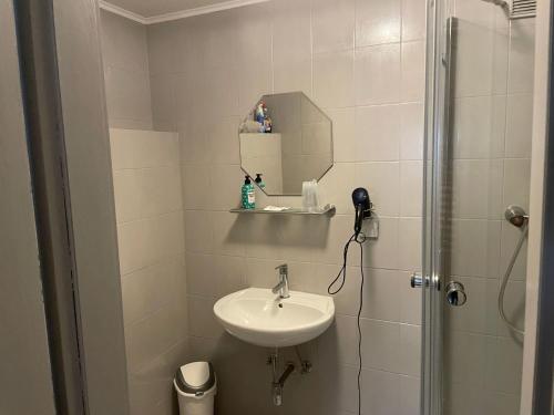 a bathroom with a sink and a shower with a mirror at Apartment Appartement Wasserfall by Interhome in Stall