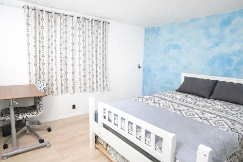 a bedroom with a white bed and a desk at Tiny but cozy manufactured house in Tampa