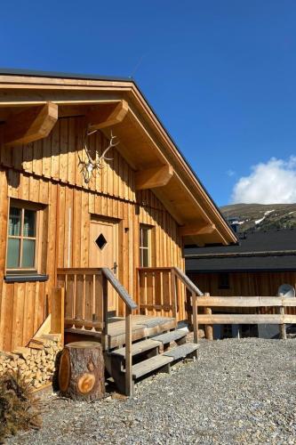 a log cabin with a porch and stairs on it at Holiday Home Jagdhütte by Interhome in Lachtal
