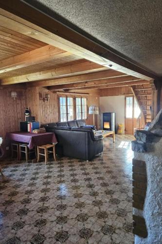 a living room with a couch and a table at Apartment Châlet Hochmatt by Interhome in Im Fang