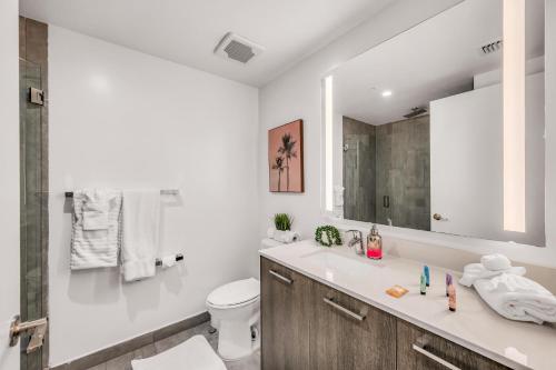 a bathroom with a sink and a toilet and a mirror at Bay Views Studio in Miami