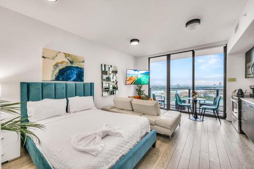 a bedroom with a large bed and a kitchen at Bay Views Studio in Miami