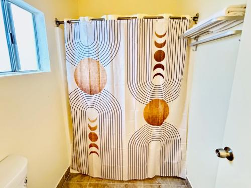a shower curtain in a bathroom with a shower at The Crest Motel in Corona