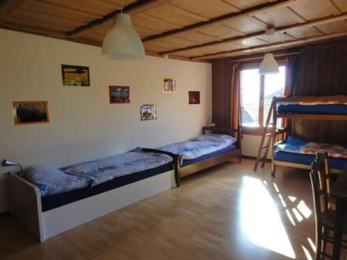 a bedroom with two bunk beds and a window at Apartment Gurtendörfli by Interhome in Wabern
