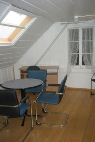 a room with a table and chairs in a attic at Apartment Leinacherhof by Interhome in Seeberg