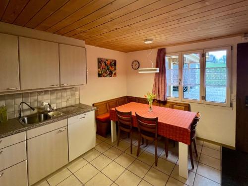 a kitchen with a table with chairs and a sink at Apartment Chalet Hulda by Interhome in Heimenschwand