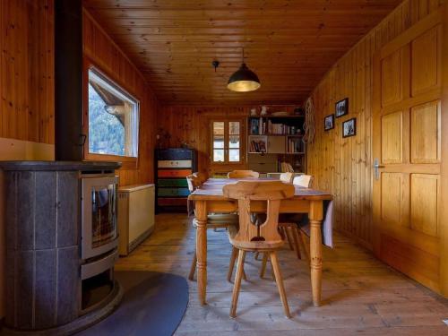 a kitchen with a wooden table and a stove at Apartment Base Camp Evolène by Interhome in Evolène