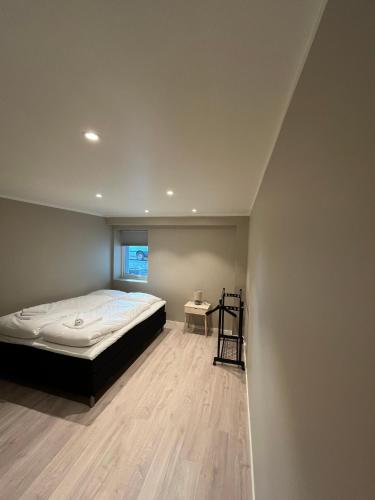 a bedroom with a large bed and a table at Skolegata 6B, 9404 Harstad in Harstad