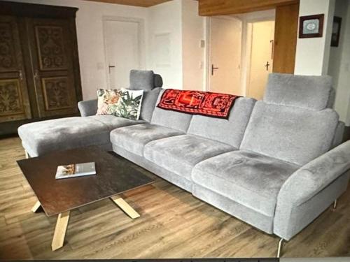 a living room with a couch and a coffee table at Apartment Panorama-Beatenberg by Interhome in Beatenberg
