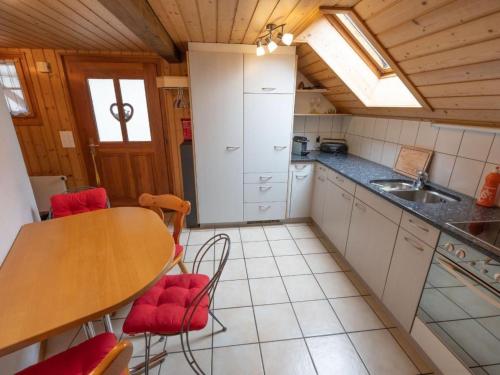 a small kitchen with a table and a sink at Apartment Muessache by Interhome in Dürrenroth