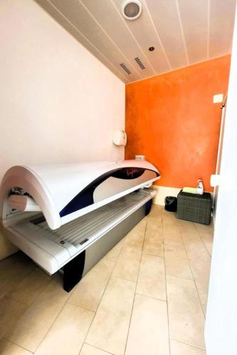 a hospital bed in a room with orange walls at Apartment Hotel Apartment by Interhome in Beatenberg