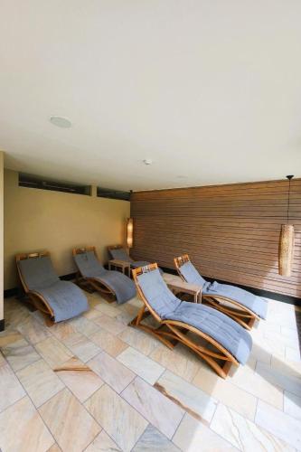 a room with three chairs and a wall at Apartment Hotel Apartment by Interhome in Beatenberg