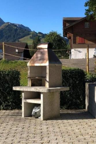 a stone oven sitting on top of a patio at Apartment Frohmatt by Interhome in Adelboden