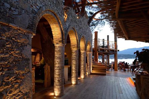 a building with arches and lights on a sidewalk at Hôtel Le Belvédère in Porto-Vecchio