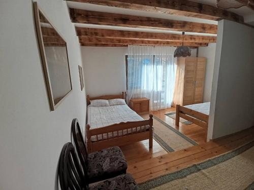 a bedroom with two beds and a couch in a room at Vikendica SANA Vlašić in Šišava