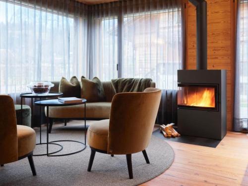 a living room with a couch and a fireplace at Apartment My Chalet by Interhome in Meiringen