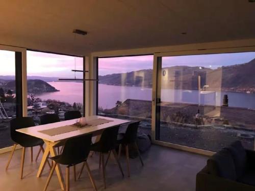 a dining room with a table and a large window at Apartment Gemütliche Apartment by Interhome in Krattigen