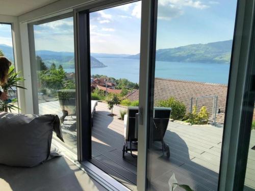 a sliding glass door with a view of the water at Apartment Gemütliche Apartment by Interhome in Krattigen