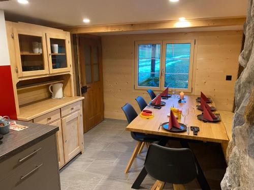 a kitchen with a long wooden table and chairs at Apartment Alpenruh by Interhome in Gadmen