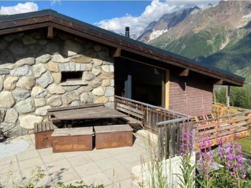 a cabin in the mountains with a stone wall at Apartment Hockenhorn by Interhome in Wiler