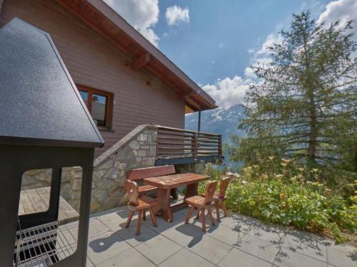 a patio with a wooden table and two chairs at Apartment Hockenhorn by Interhome in Wiler