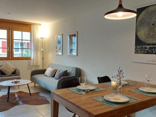 a living room with a table and a couch at Apartment Aspa EG by Interhome in Bellwald
