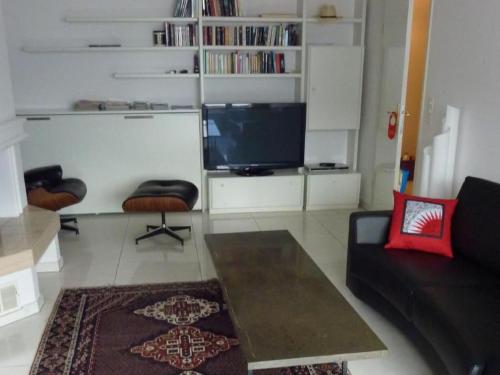 a living room with a couch and a tv at Apartment Apartment 360 by Interhome in Lucerne
