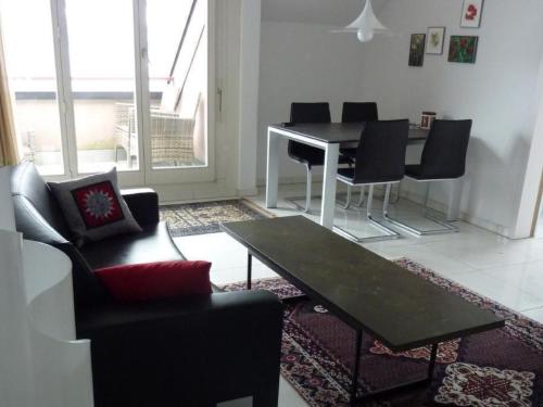 a living room with a table and chairs at Apartment Apartment 360 by Interhome in Lucerne