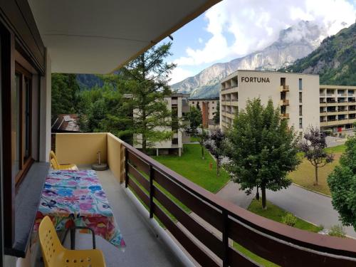a balcony with a table and chairs and a view at Apartment Royal 22 nahe Klinik- Burgerbad- Einkaufszentrum by Interhome in Leukerbad
