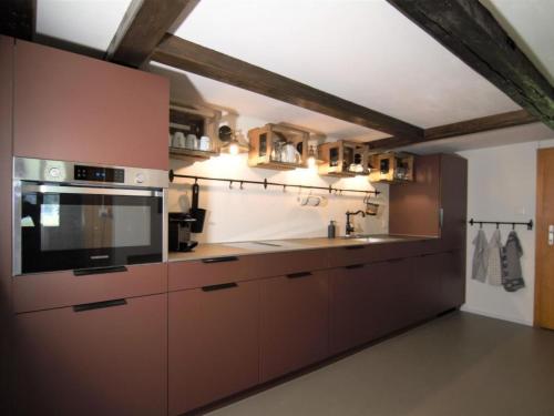 a kitchen with a sink and a microwave at Apartment Lungern by Interhome in Lungern