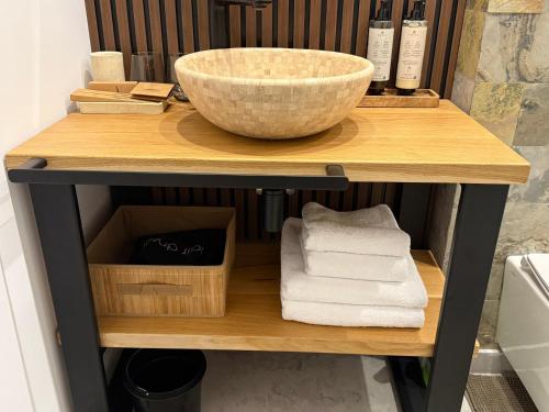 a counter with a bowl and towels on a shelf at Cozy Cribs Rasnov in Râşnov