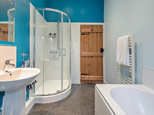 a bathroom with a glass shower and a sink at 2 Bed in Keswick oc-sz006 in Keswick