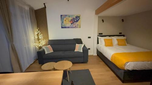 a living room with a bed and a couch at Cozy Cribs Rasnov in Râşnov