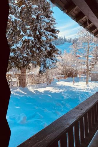 a view of a snow covered yard from a balcony at Apartment Chalet Bacchus - EG by Interhome in Sörenberg