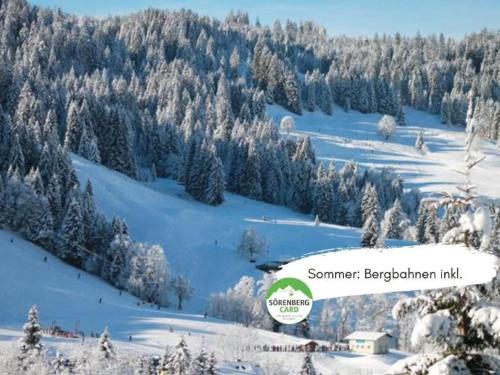 a snow covered hill with trees on a mountain at Apartment Baldo by Interhome in Sörenberg