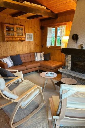 a living room with a couch and a fireplace at Holiday Home Chalet Glücksfall by Interhome in Bellwald