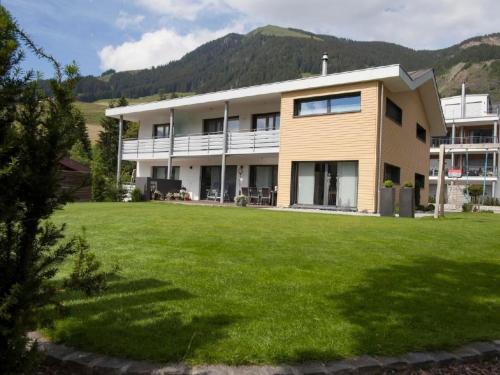 a house with a large lawn in front of it at Apartment Lauigrund by Interhome in Sörenberg
