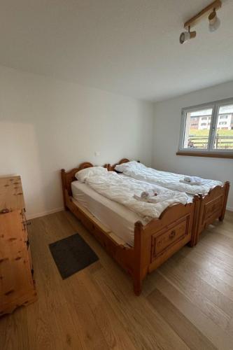 a bedroom with a large wooden bed in a room at Apartment Sonnehüsli by Interhome in Flühli