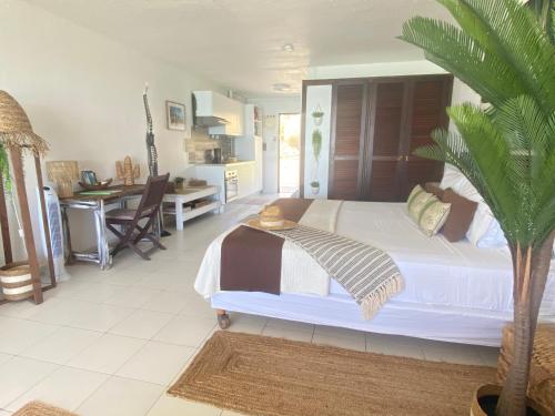 a bedroom with a bed with a palm tree in it at Excellence Suites Orient Beach Oceanview King-Size Beach Pool Parking in Cul de Sac