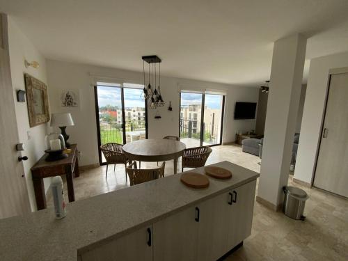 a kitchen and living room with a table and chairs at LUMINARIA Pool, Near the Historic Center | Elegant in San Miguel de Allende