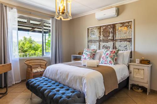 a bedroom with a large bed and a window at Shekinah Cabin in Hartbeespoort
