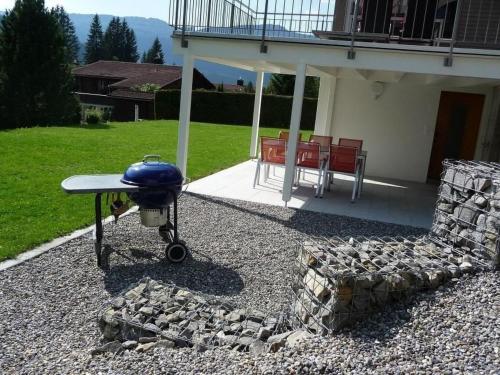 a grill sitting on top of a gravel patio at Apartment Saturn by Interhome in Sörenberg