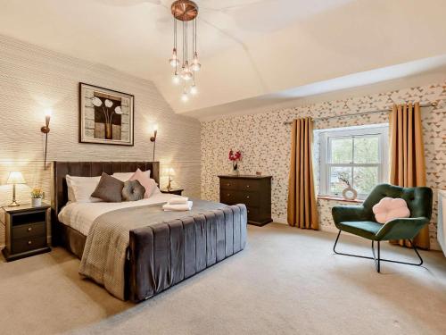 a bedroom with a bed and a chair and a window at 3 Bed in Egremont oc-90050 in Hale