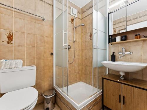 a bathroom with a shower and a toilet and a sink at Apartment Lake View Studio by Interhome in Ingenbohl