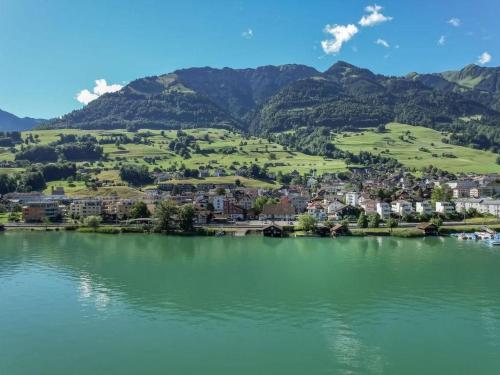 a lake with a town and mountains in the background at Holiday Home Verena's B&B by Interhome in Sachseln