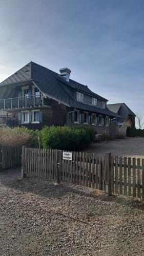 a house with a wooden fence in front of it at Brend Hotel und Gasthof in Furtwangen